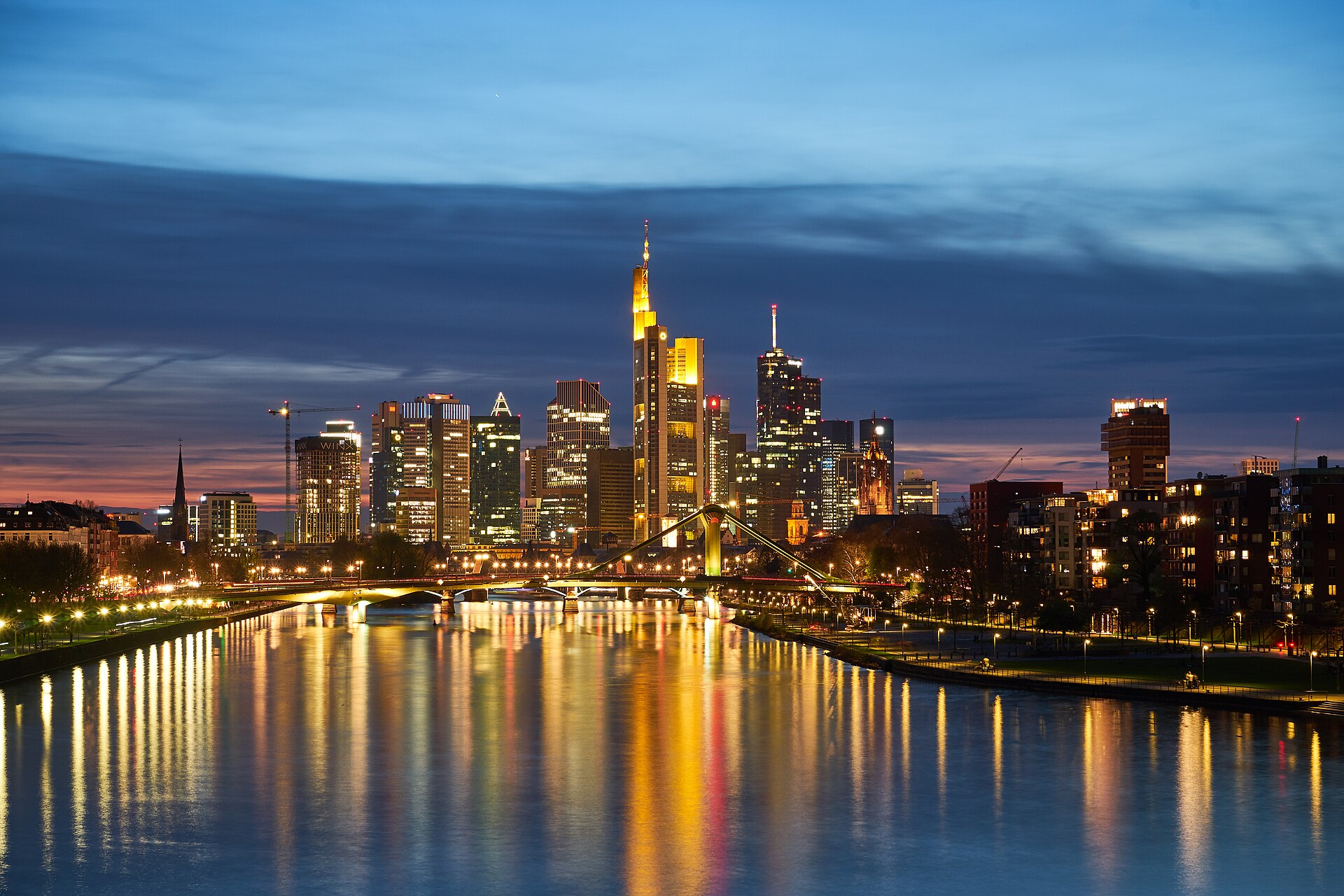 Frankfurt skyline with illuminated office towers at night, seen from the Main river