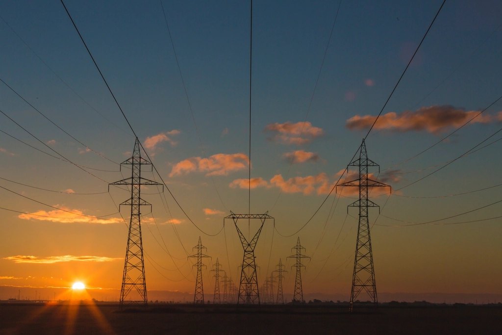 Grid connection queue: electricity pylons at sunset